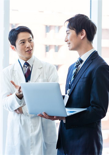 医師と担当者が資料を見ながら相談する様子